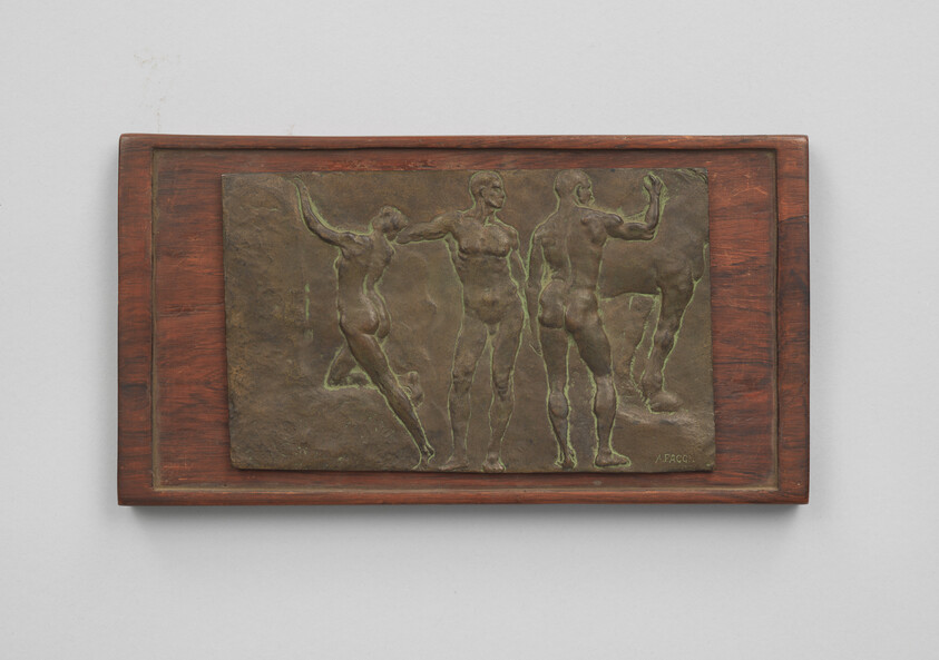 Bronze relief sculpture shows three nude human figures standing and moving, mounted on a wooden plaque.