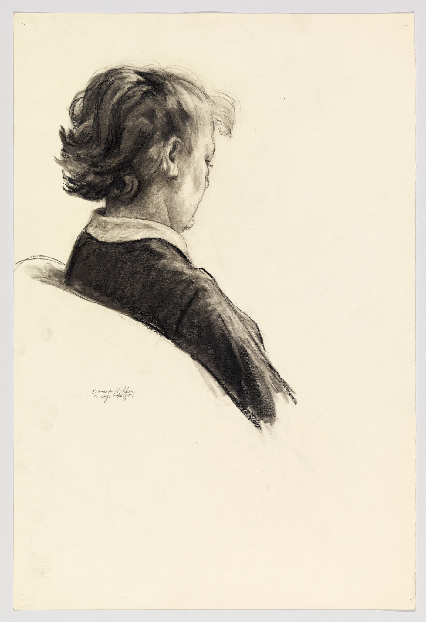 Woman with short wavy hair seated in profile, head slightly bowed and shoulders relaxed.