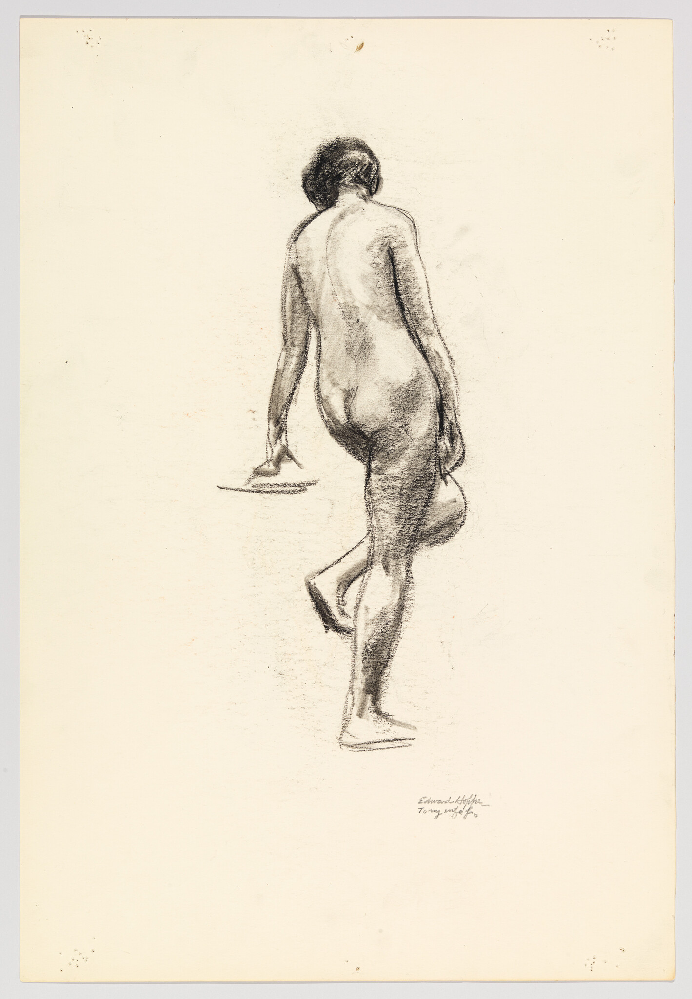 Nude woman seen from behind stepping forward while holding a hat.