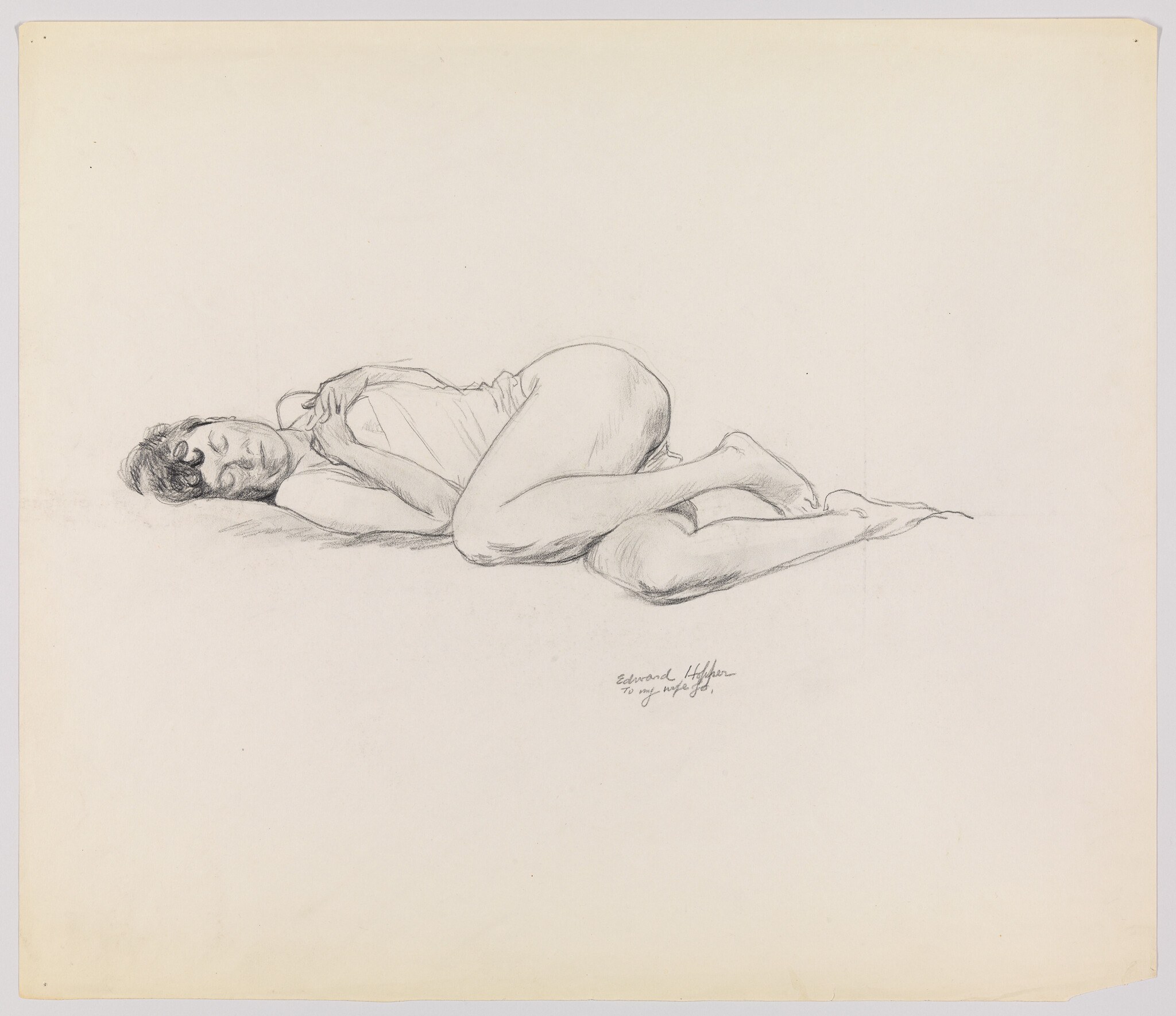 A woman lies curled on her side with hands near her chest and eyes closed.