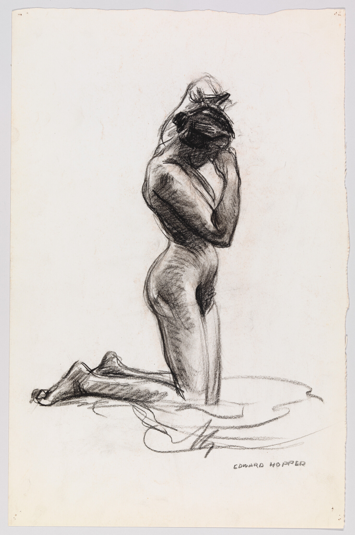 A nude woman kneels on cloth while lifting her arms to adjust her hair.