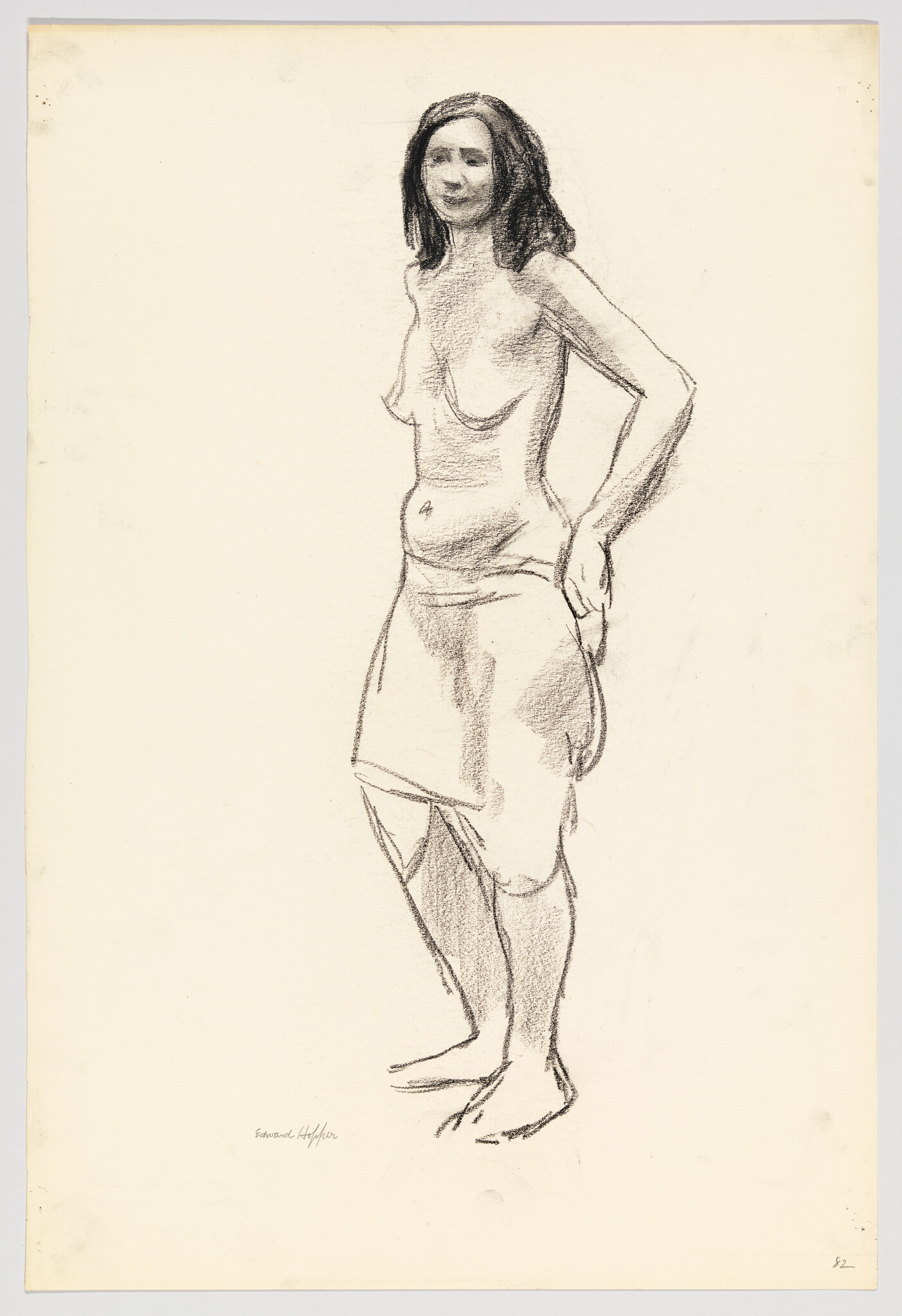 A standing woman with hands on her hips wearing a skirt in a charcoal sketch.