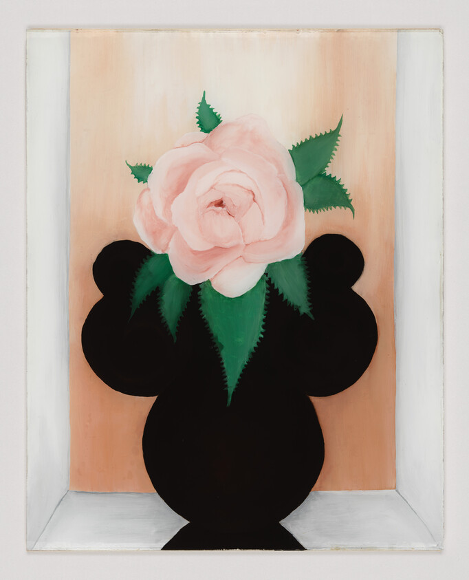 A pale pink rose with green leaves sits in a rounded black vase against a peach background.