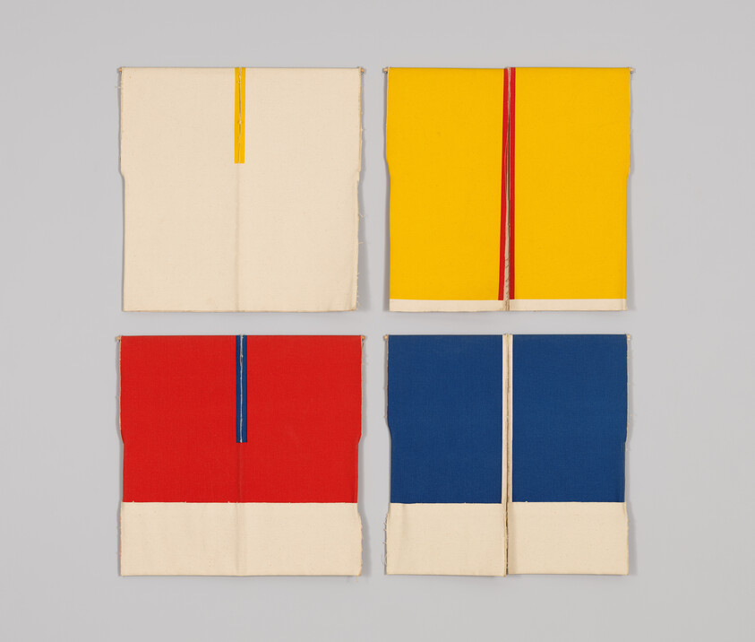 Four folded fabric panels in a two-by-two grid showing cream, yellow, red, and blue sections.