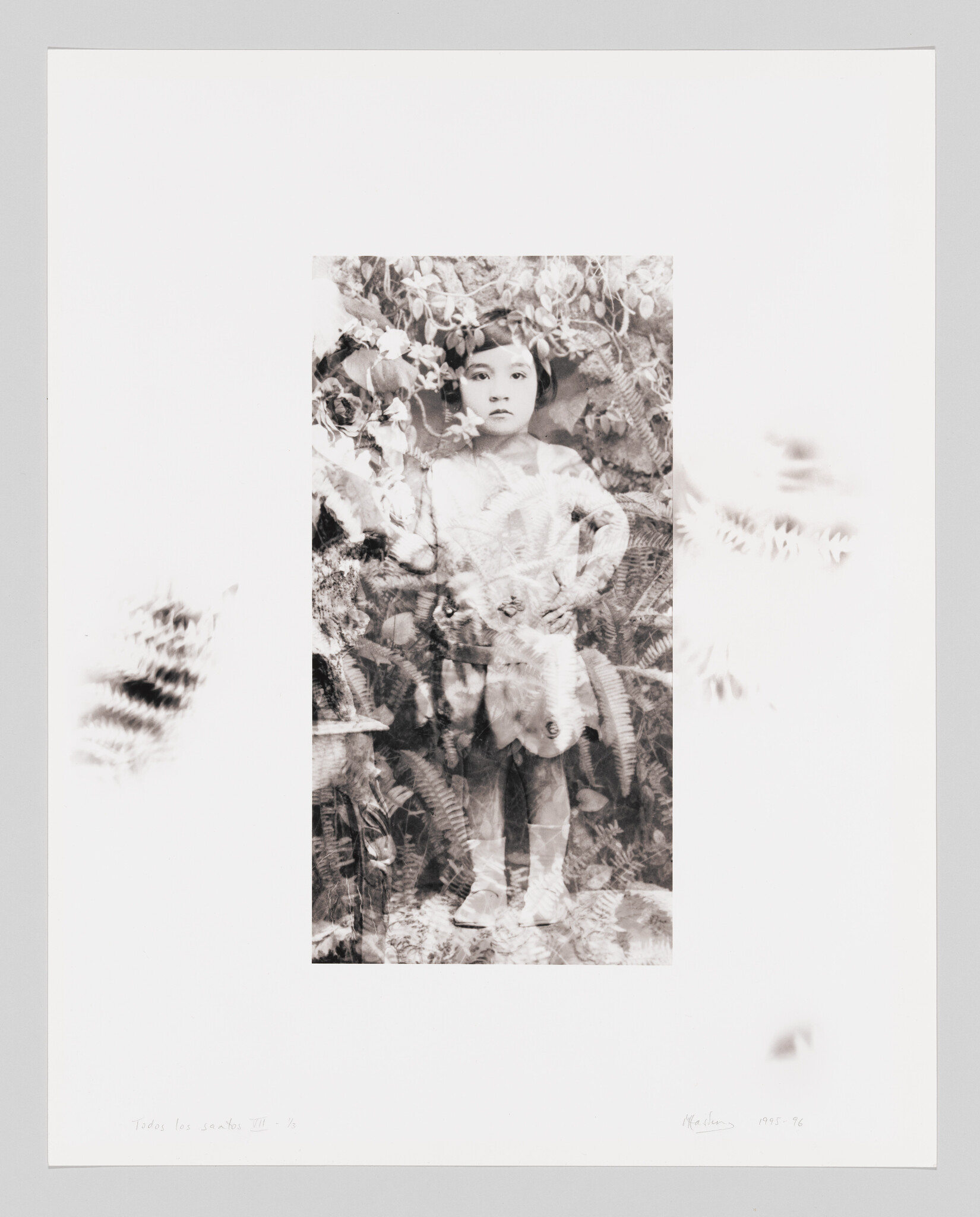 Young girl stands with hands on hips amid layered ferns and flowers in a faded black-and-white portrait.