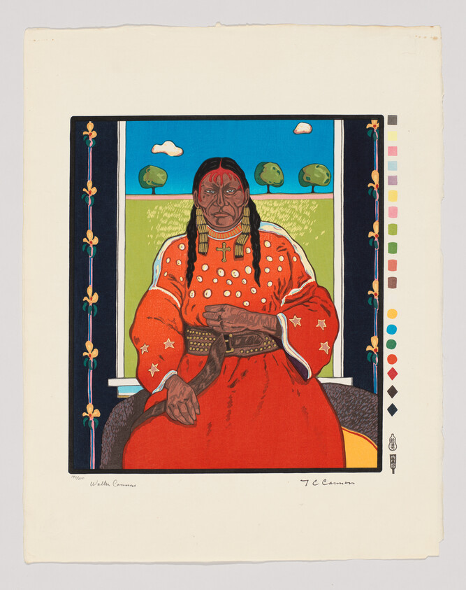 Person in a red robe with a cross necklace sits in front of a window with trees outside.