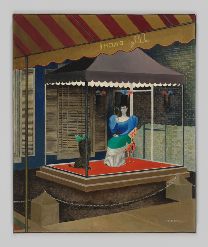 Woman in a bright dress sits under a striped canopy holding a small mirror on display.