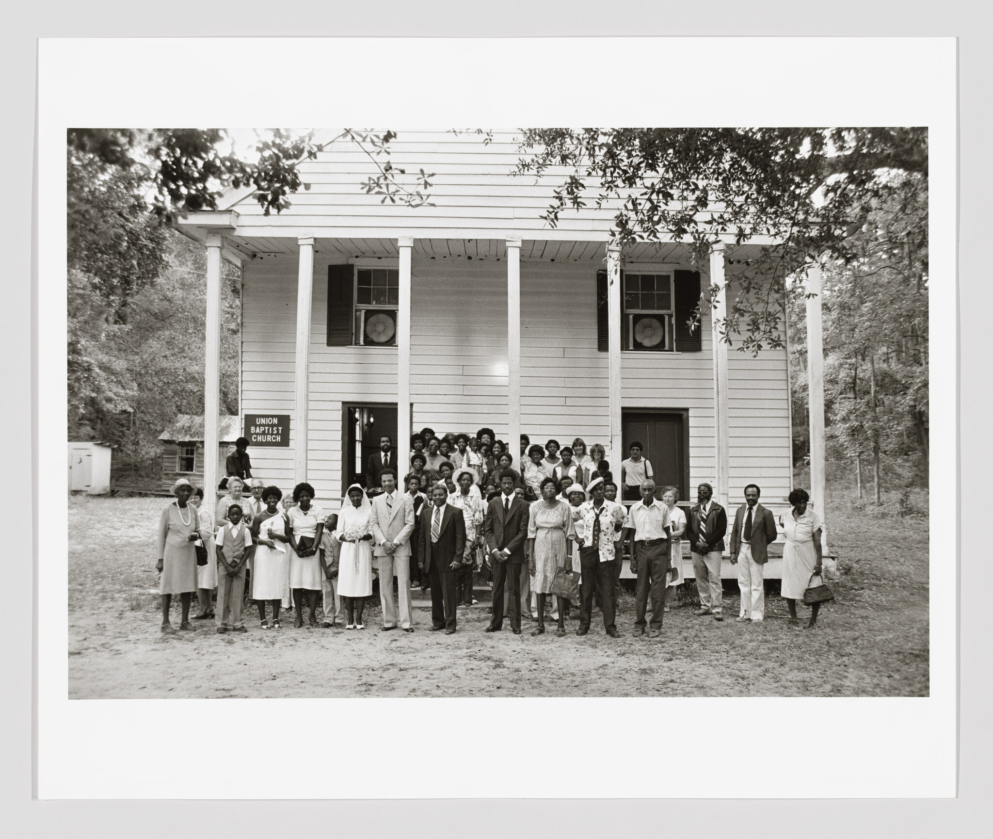 A large congregation poses for a group photo in front of Union Baptist Church.