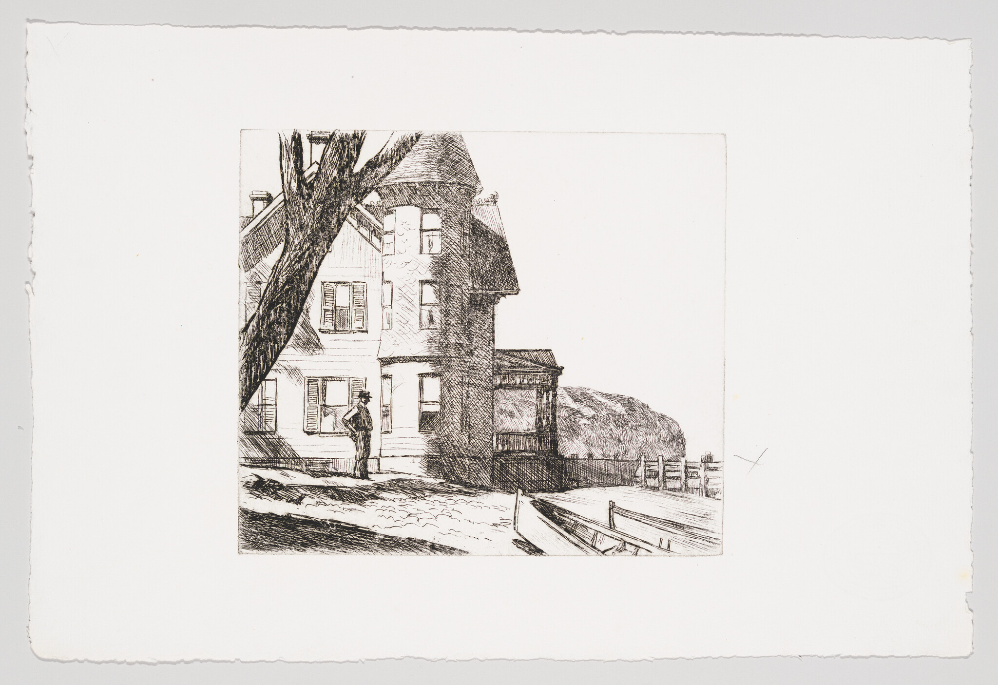 A man stands outside a large Victorian house near a dock and rowboat.