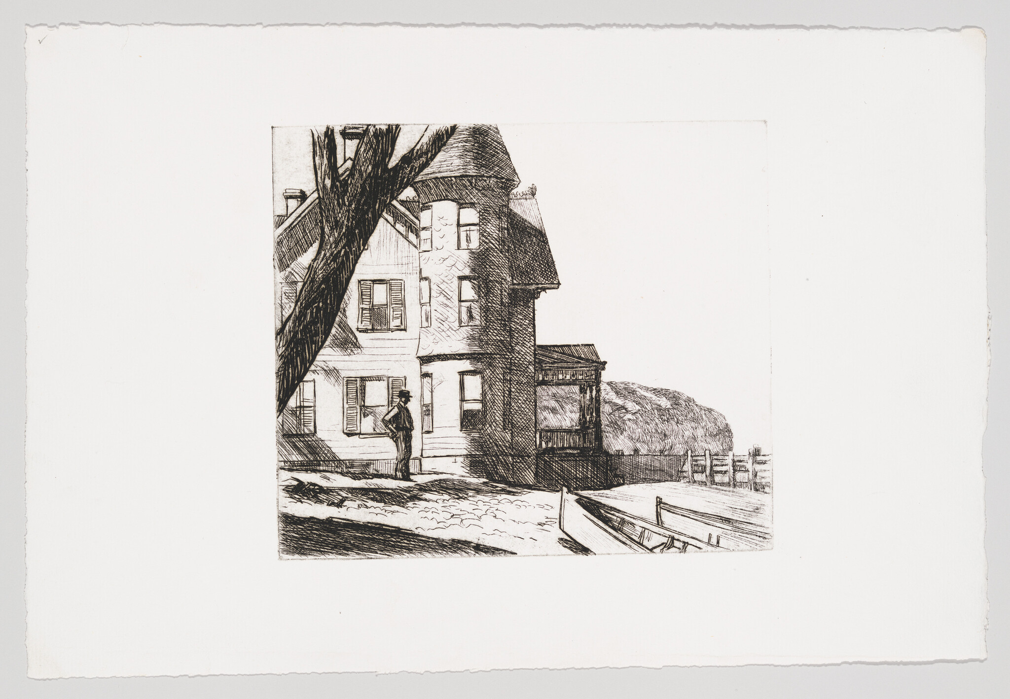 A person stands outside a Victorian house beside a dock and a small rowboat.