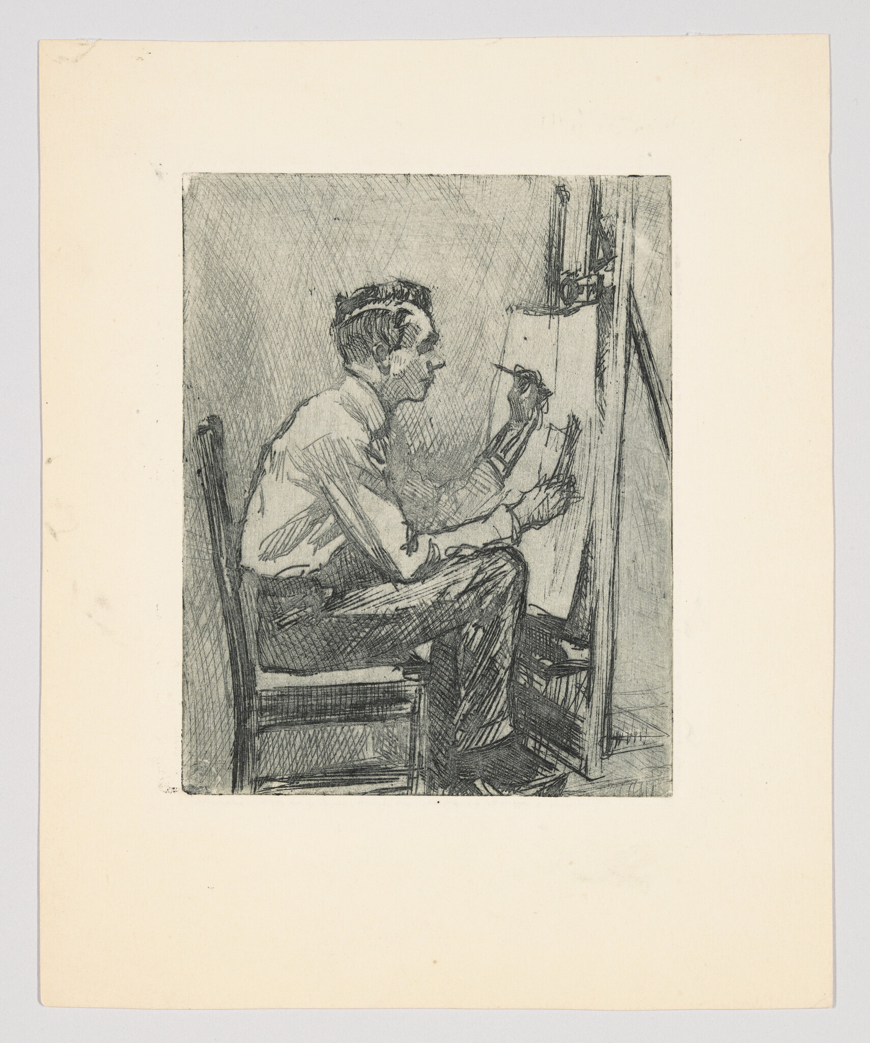 A man sits on a chair sketching on a canvas at an easel.