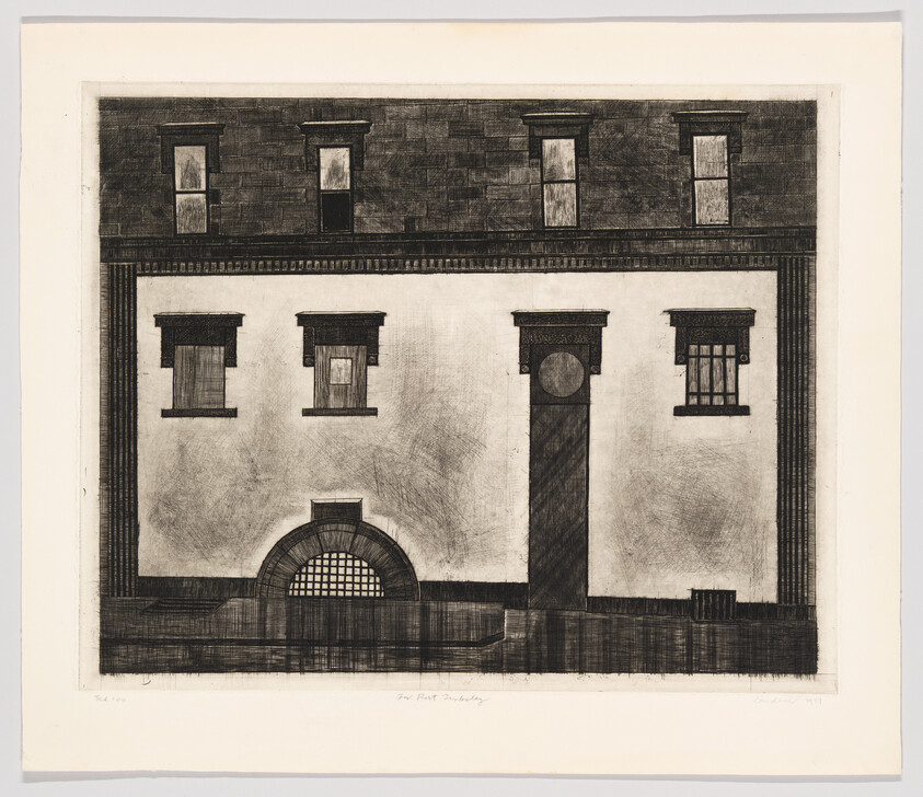 A symmetrical building facade with three upper windows, three lower openings, and an arched grated entrance.