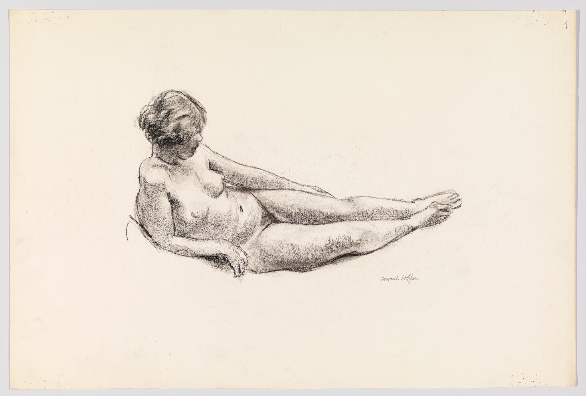 A reclining nude woman is drawn in charcoal, looking down with legs extended.