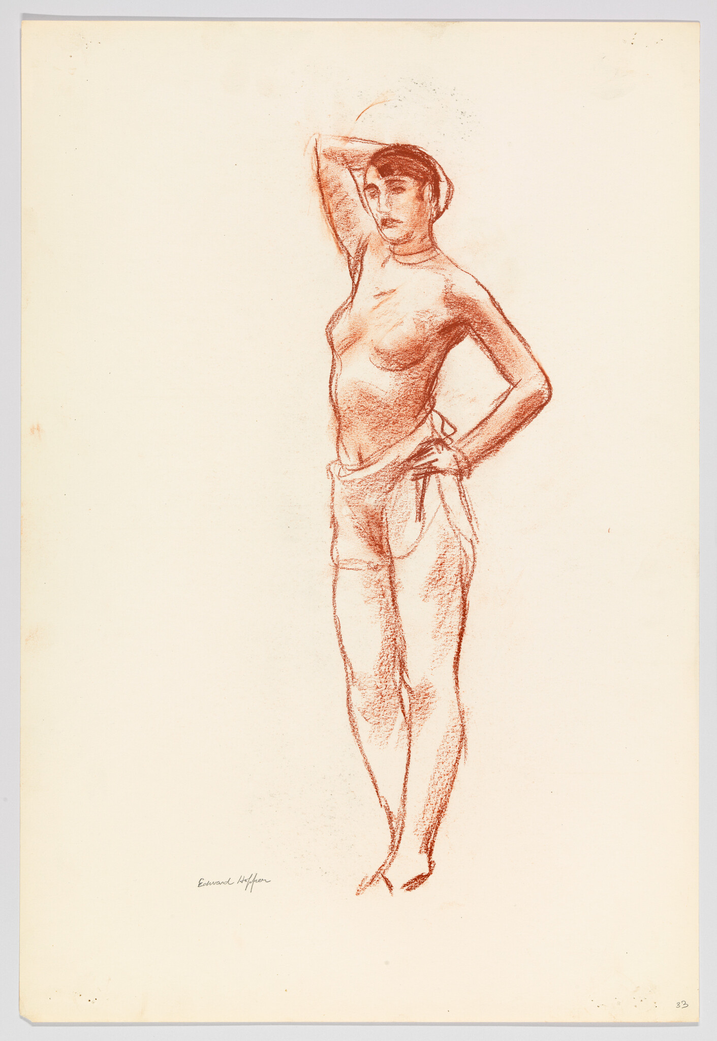 Standing woman with one hand behind her head and the other on her hip, wearing trousers.