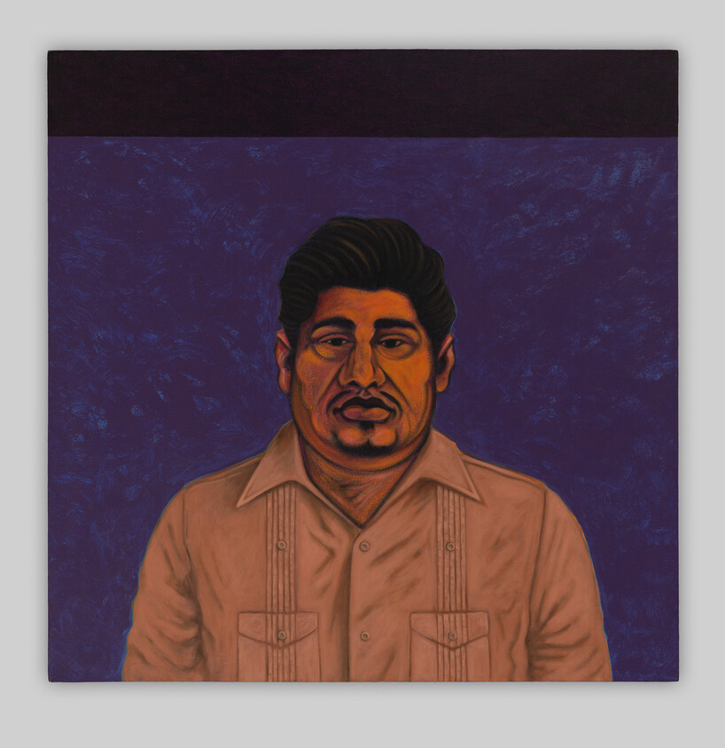 Man with dark hair wearing a buttoned guayabera-style shirt against a deep purple background.