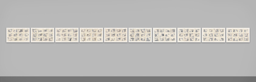 Eleven framed artworks with multiple small sketches are displayed in a row on a white wall.