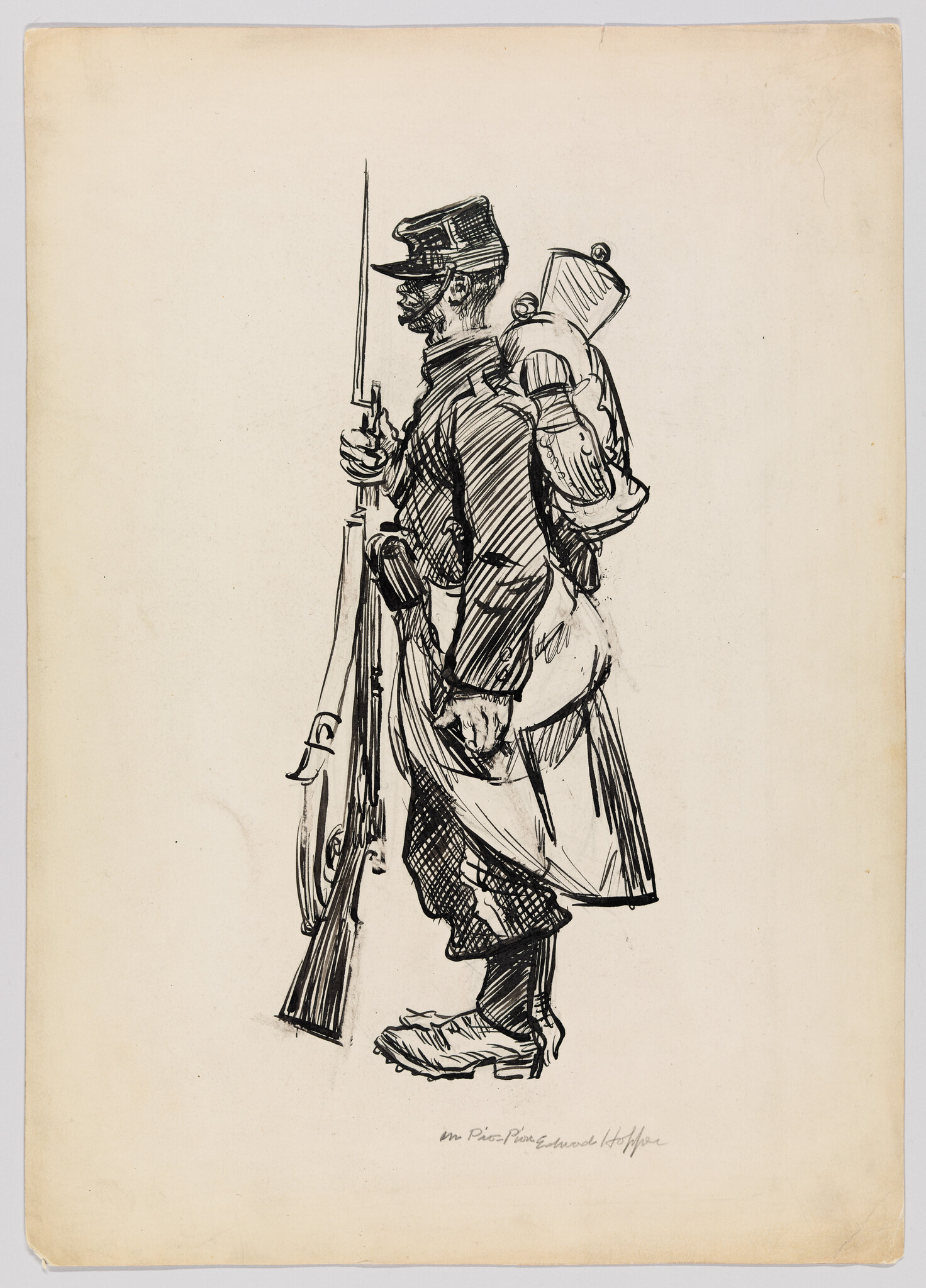 A soldier stands in profile holding a rifle with bayonet and wearing a large backpack.