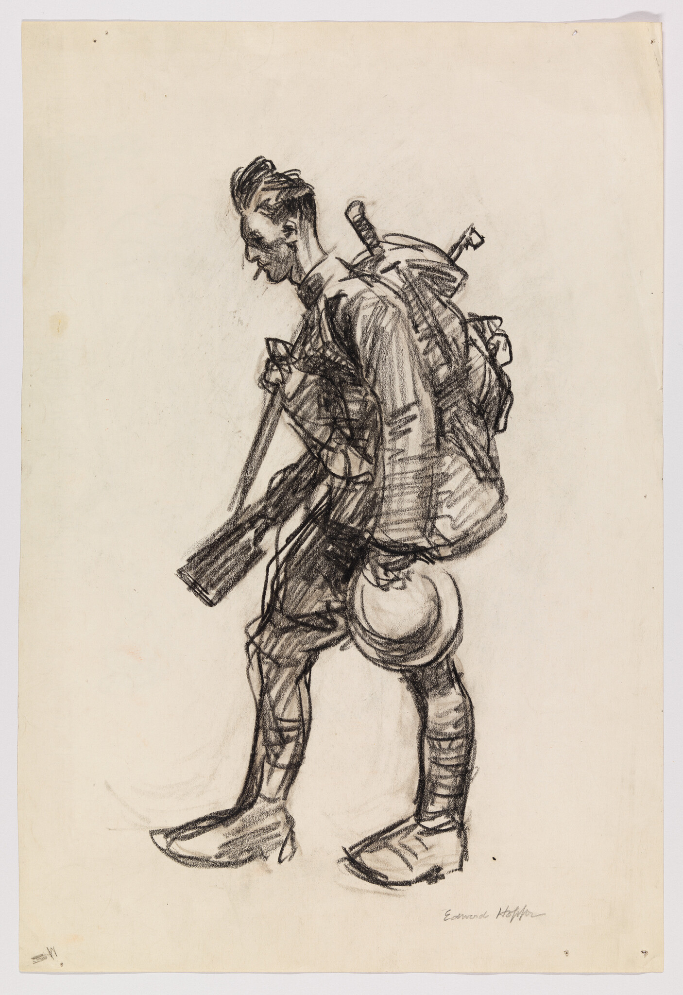 A weary soldier marches forward carrying a large backpack, rifle, and helmet.