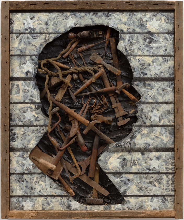 Silhouette of a head made from various rusty tools and ropes, set against a textured background with star patterns, framed in wood.