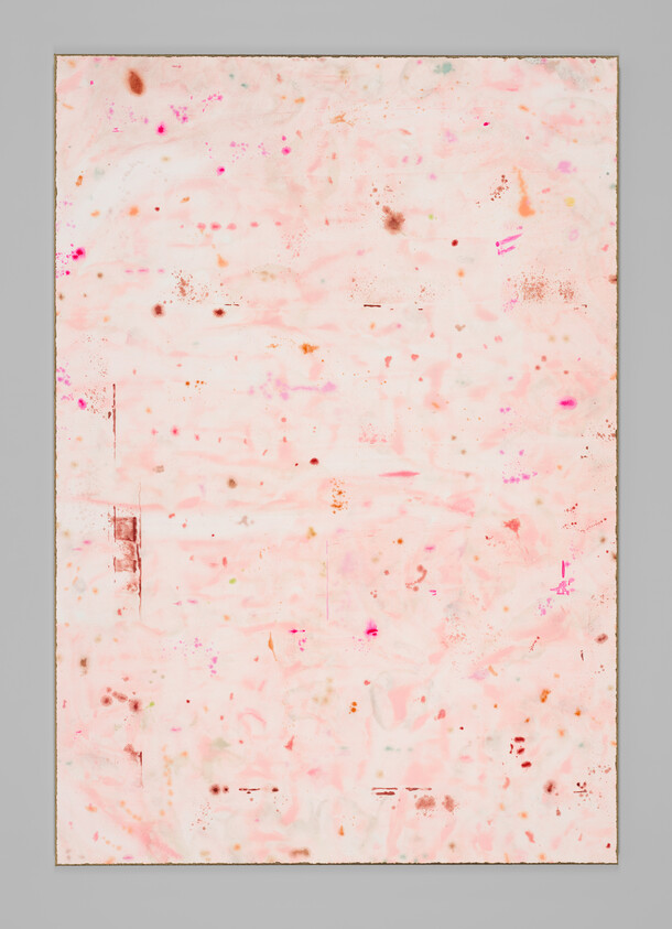 Large pale pink abstract painting with scattered orange and magenta specks on a gray wall.