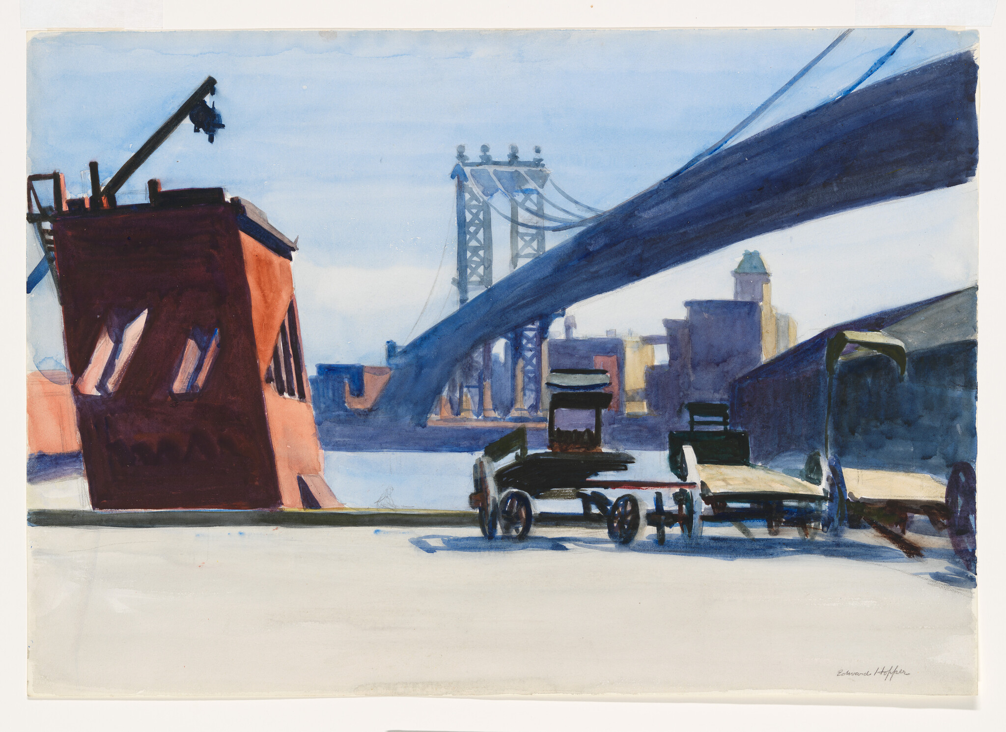 A waterfront scene with empty wooden carts under a large suspension bridge and city skyline.