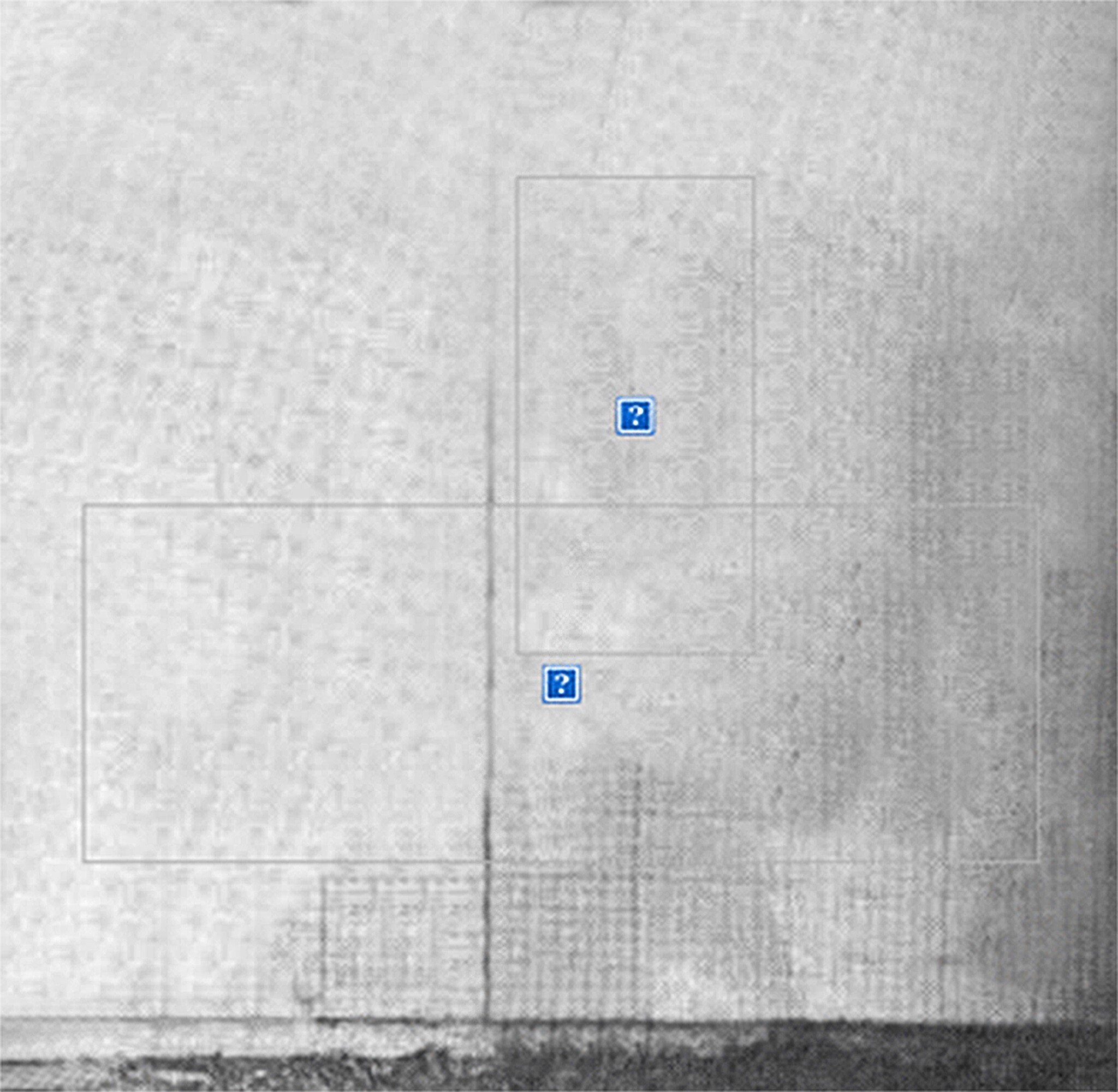 Gray textured surface with two blue question mark icons inside rectangles, possibly indicating missing or hidden content.