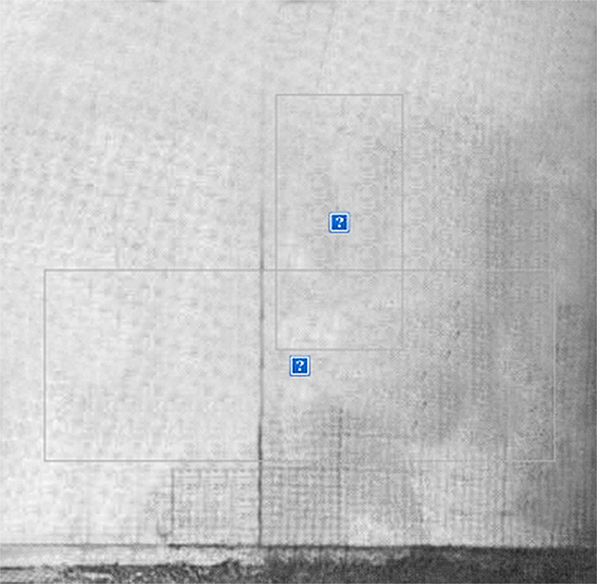 Faded wall with overlapping rectangular outlines and two small blue question-mark icons near the center.