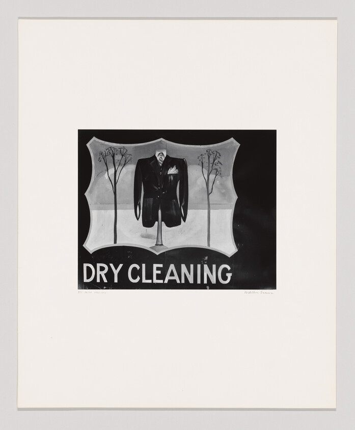 A suit jacket displayed on a mannequin with 'Dry Cleaning' sign beneath it.