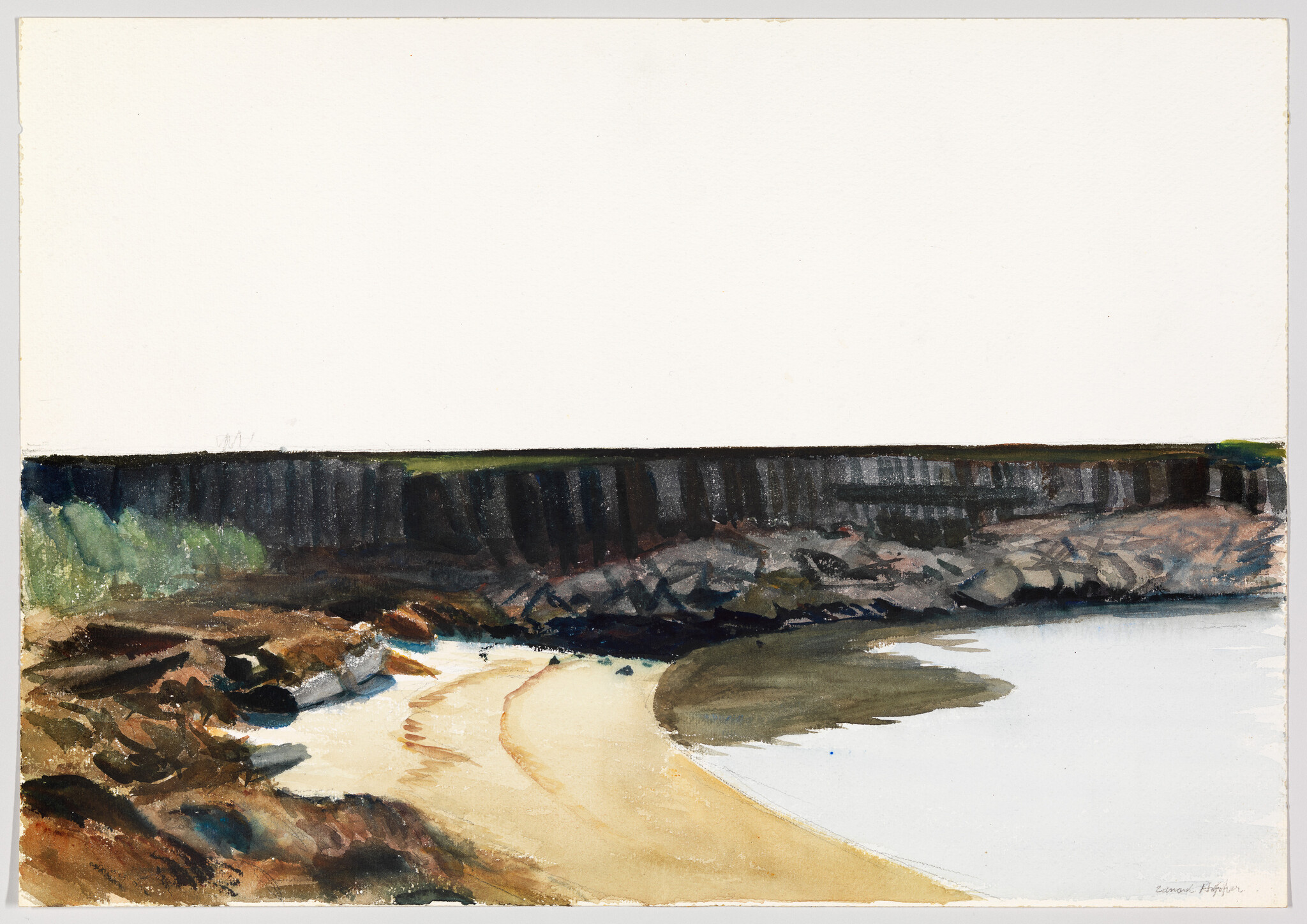 A quiet sandy cove with rocky cliffs and calm water under a wide blank sky.