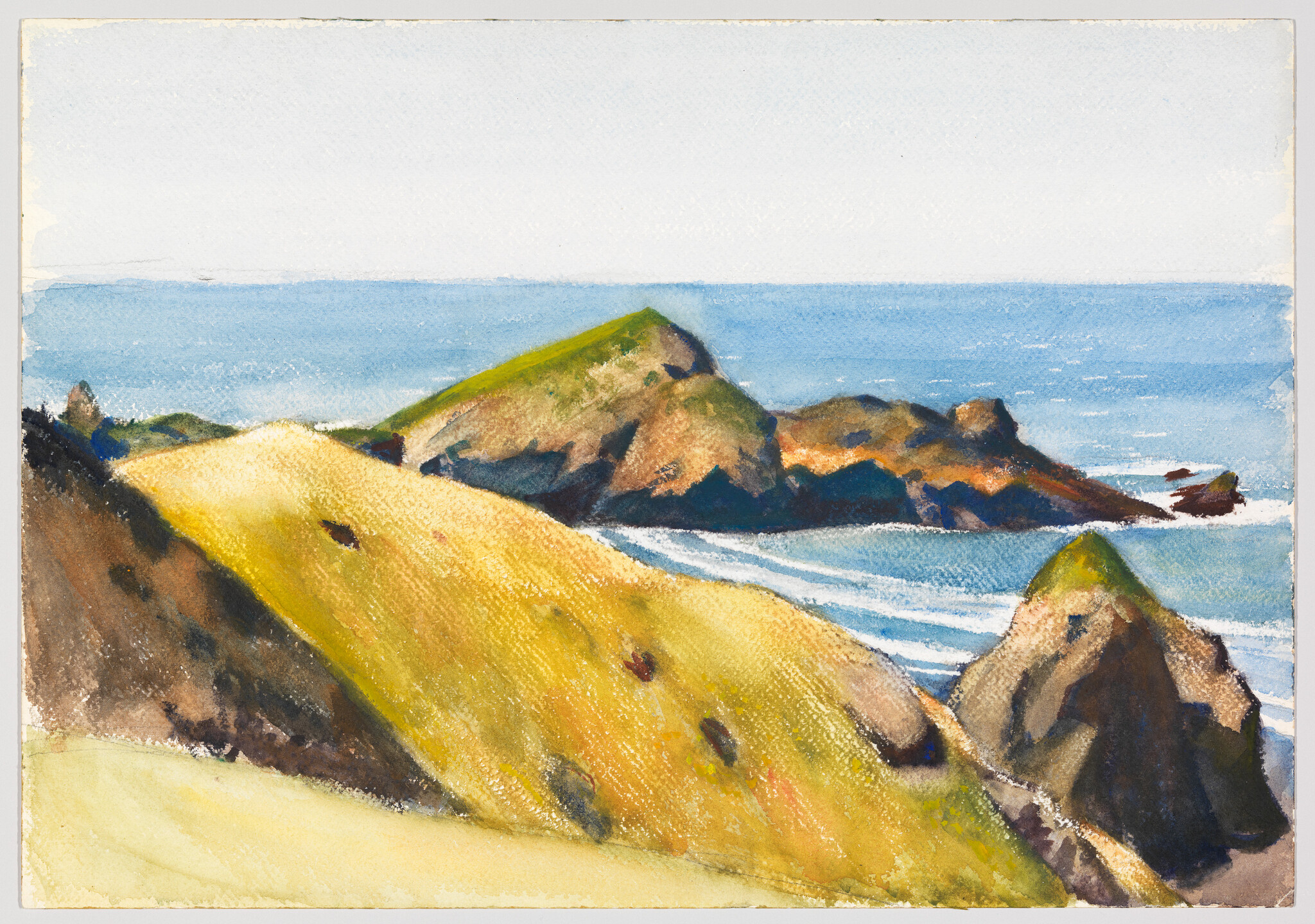 Golden grassy cliffs slope toward rocky sea stacks with gentle waves under a pale sky.
