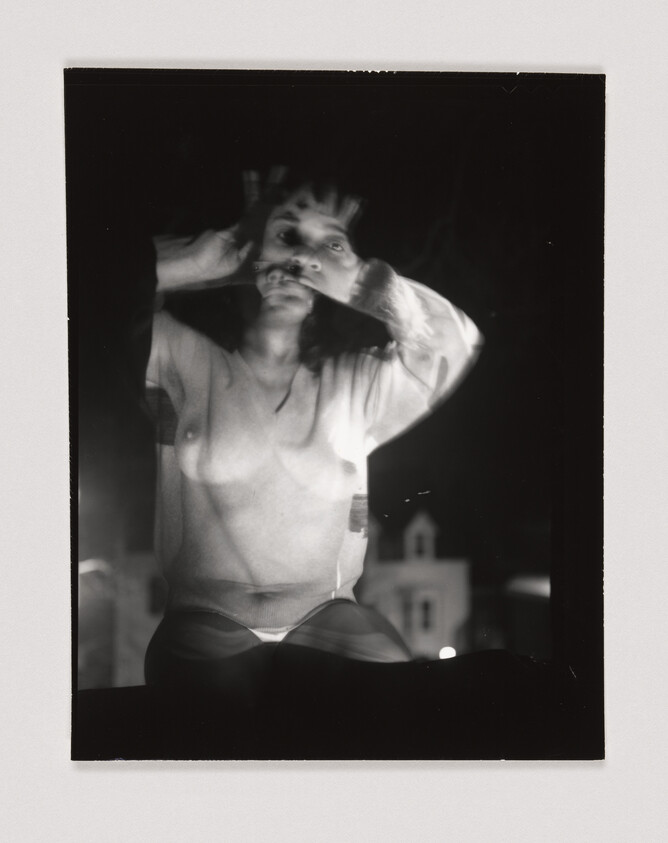 A blurred double-exposed person with bare chest raises hands to their face against a dark background.
