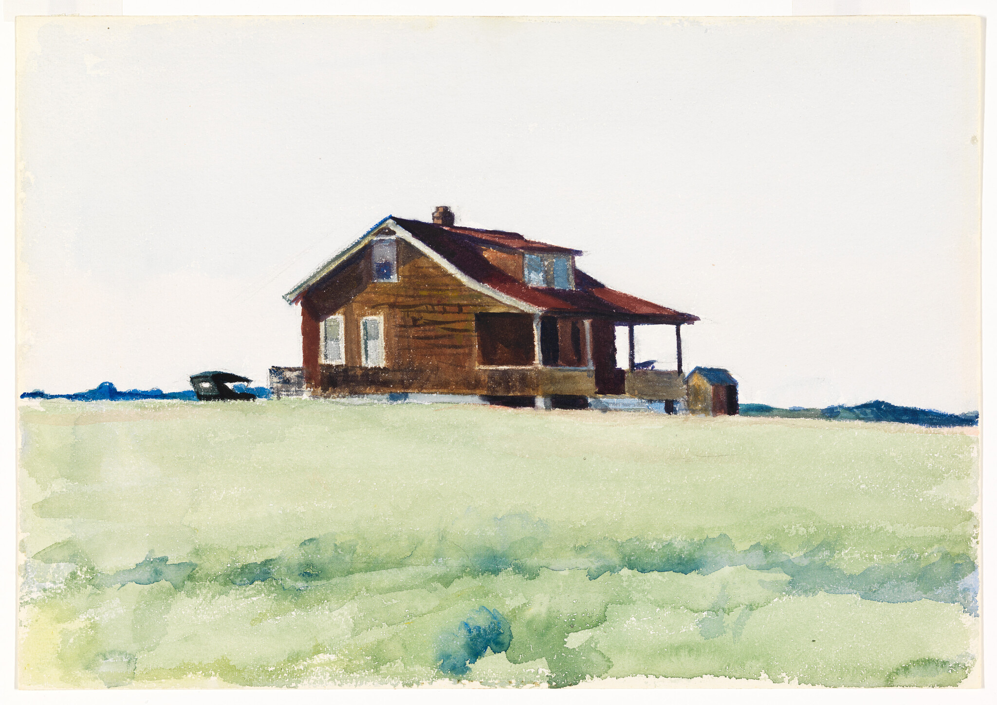 A lone brown wooden house sits on a wide green field with a small nearby shed.