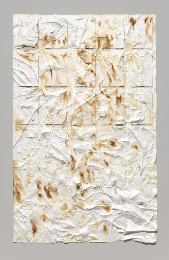 Textured white paper with brown stains and creases, arranged in a grid pattern, creating an abstract, layered appearance.