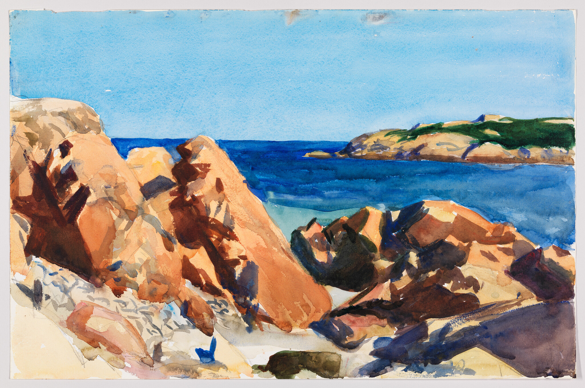 Rugged orange rocks along a bright blue sea with a small distant green headland.