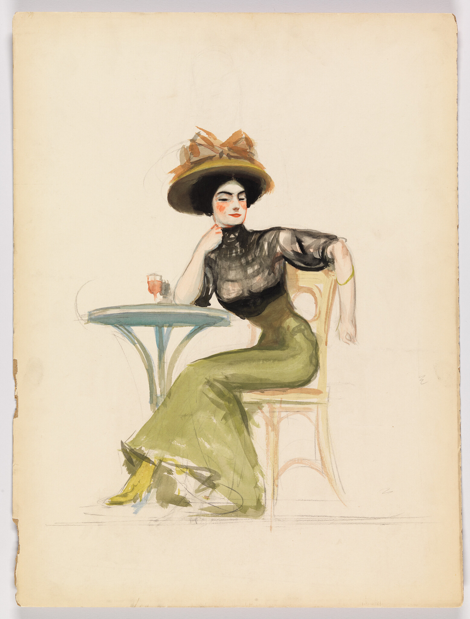 A fashionable woman in a large hat sits at a café table with a small glass.