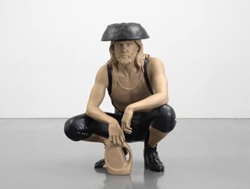A sculpture of a man squatting, wearing a black hat and pants, holding a plastic container.
