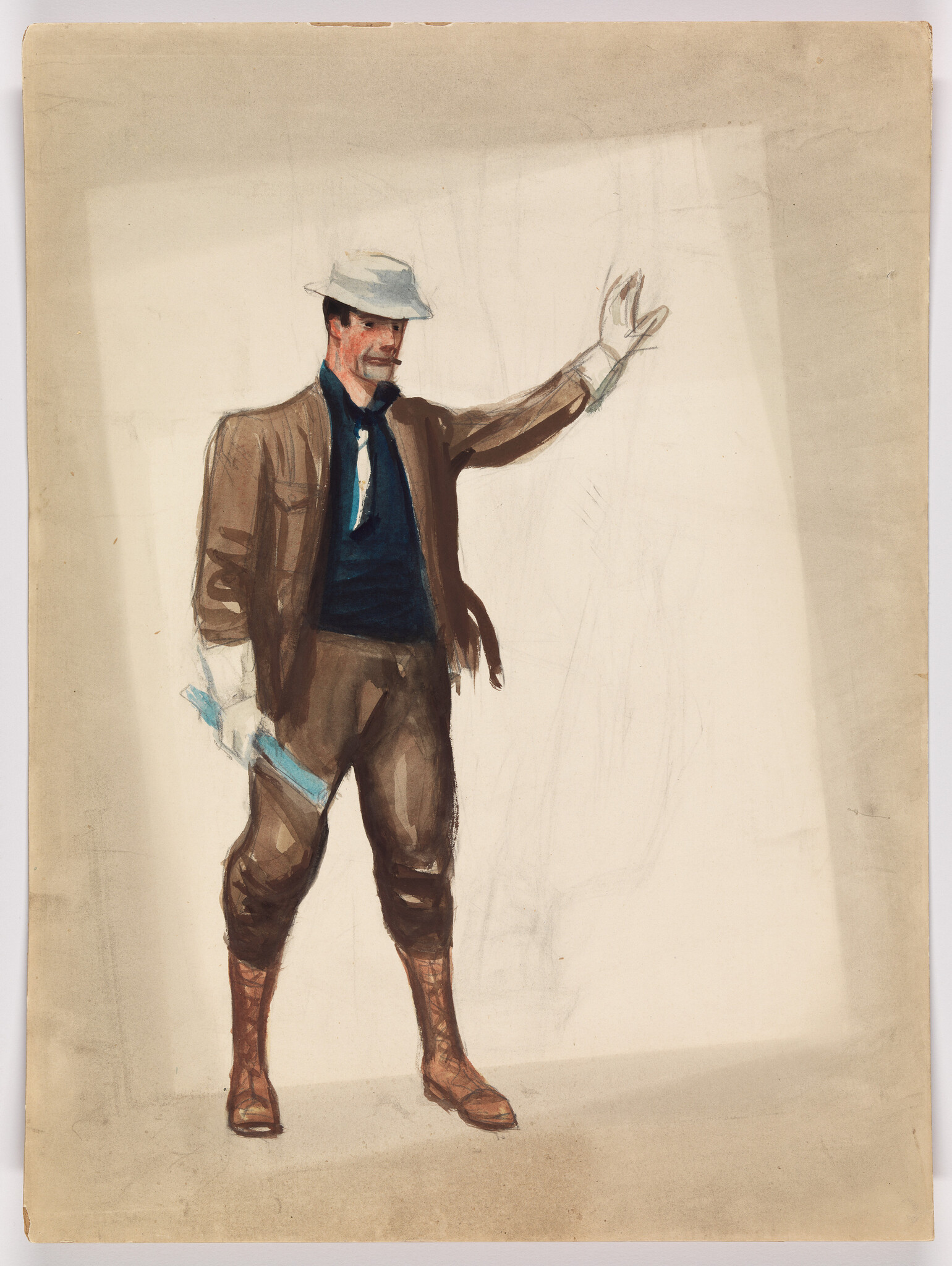 A man in a hat and brown suit raises his right hand while holding a rolled paper.