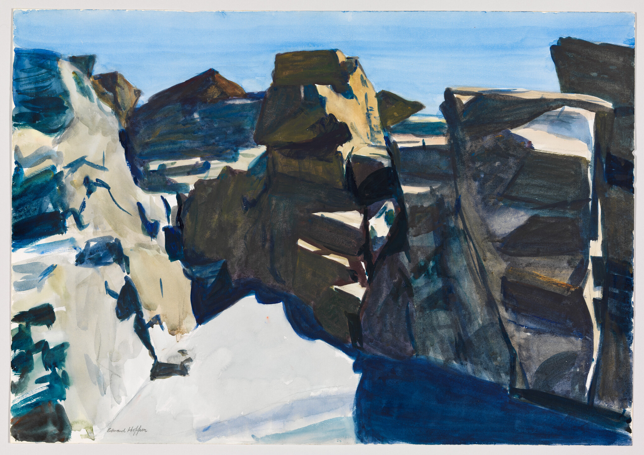 Large dark coastal cliffs and lighter rock faces under a clear blue sky.