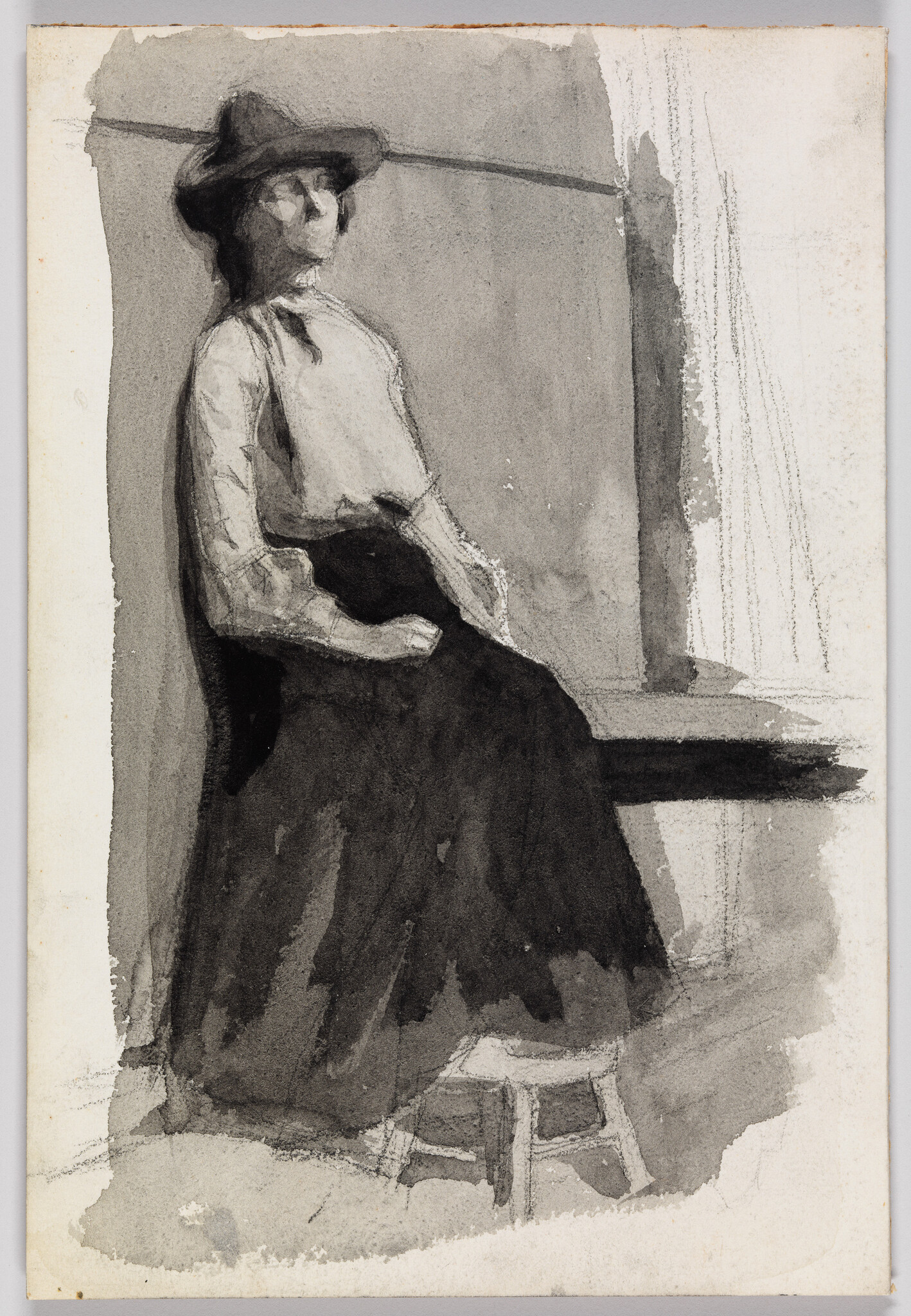 A woman wearing a hat sits on a stool with hands resting in her lap.