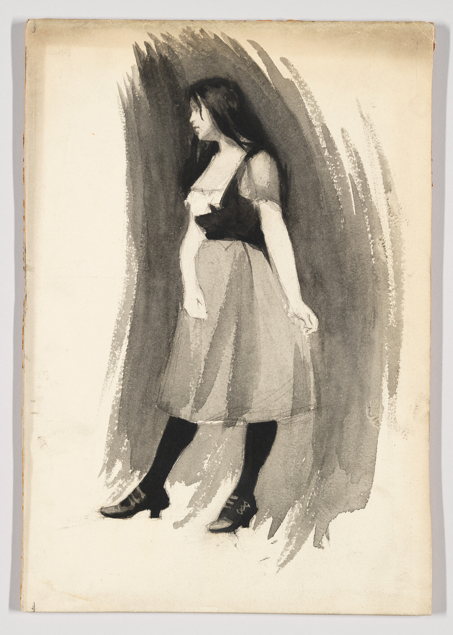 A young woman stands in a simple dress and stockings, holding her skirt and looking left.