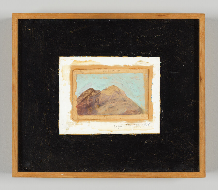 Small mountain landscape painting with blue sky mounted on a black mat inside a wooden frame.
