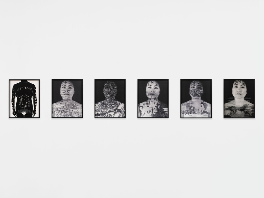 Six framed black-and-white portraits with layered text and images displayed evenly on a white wall.