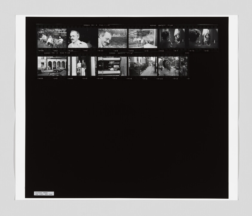 Small black-and-white film contact sheet showing two rows of thumbnail portraits and street scenes.