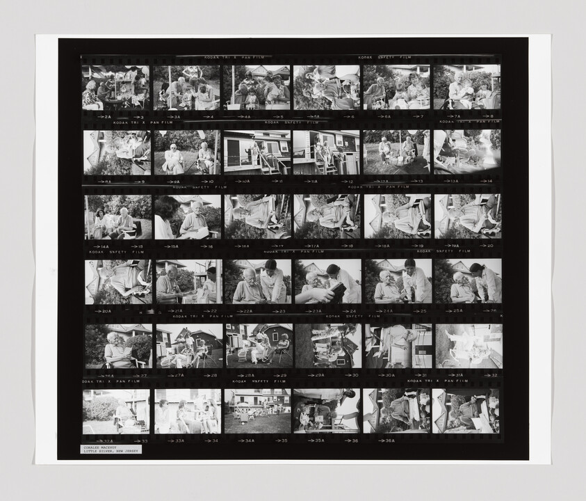 A contact sheet shows multiple black-and-white photos of people sitting and talking outside near a house.