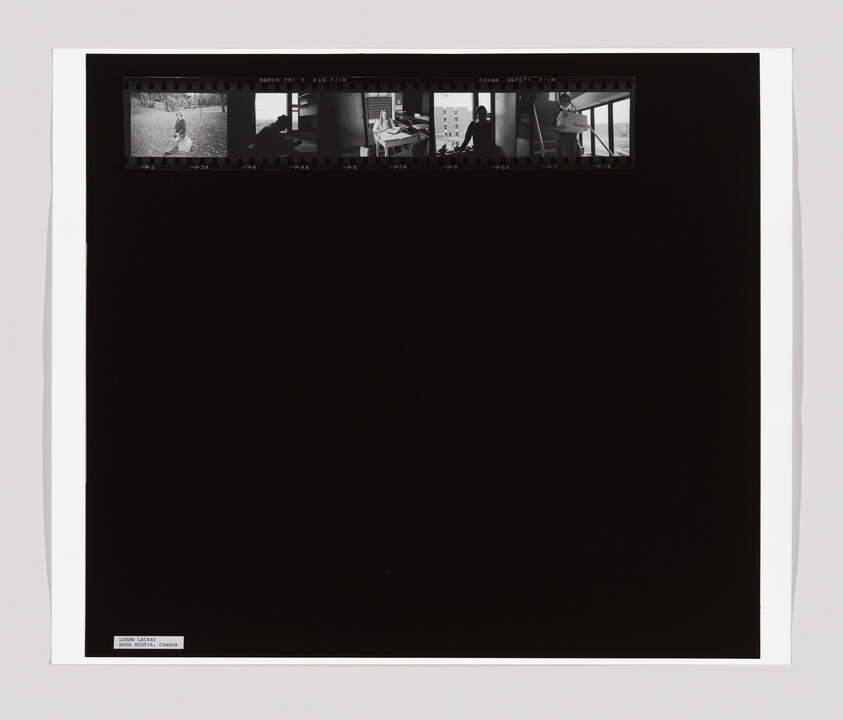 A large dark film sheet with a row of five small black-and-white contact prints across the top.