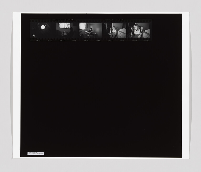 Black-and-white contact sheet showing five small frames of a toddler sitting in a high chair.