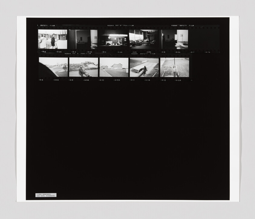 Black-and-white contact sheet with a row of small thumbnail photos along the top and large black margin below.