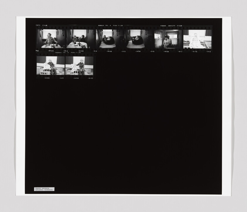 A contact sheet with small black-and-white photos of a person sitting at a table and holding a baby.