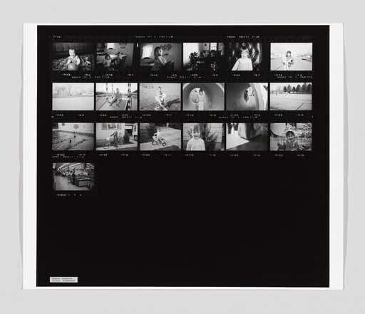 Black-and-white contact sheet showing multiple small family photos of children playing, riding bikes, and posing.