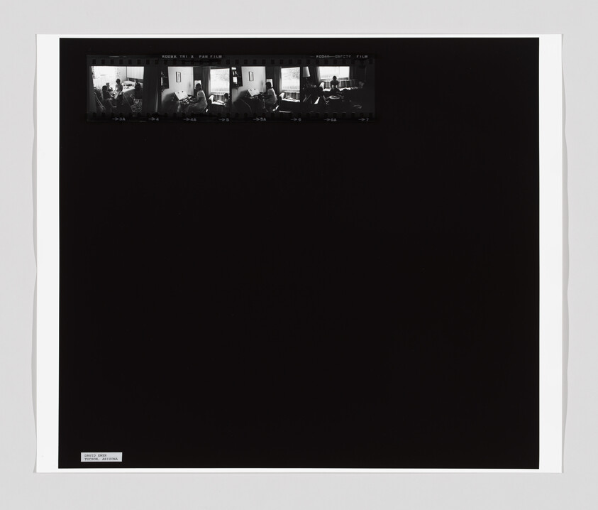 Small film strip at top shows people sitting by a window in a living room.